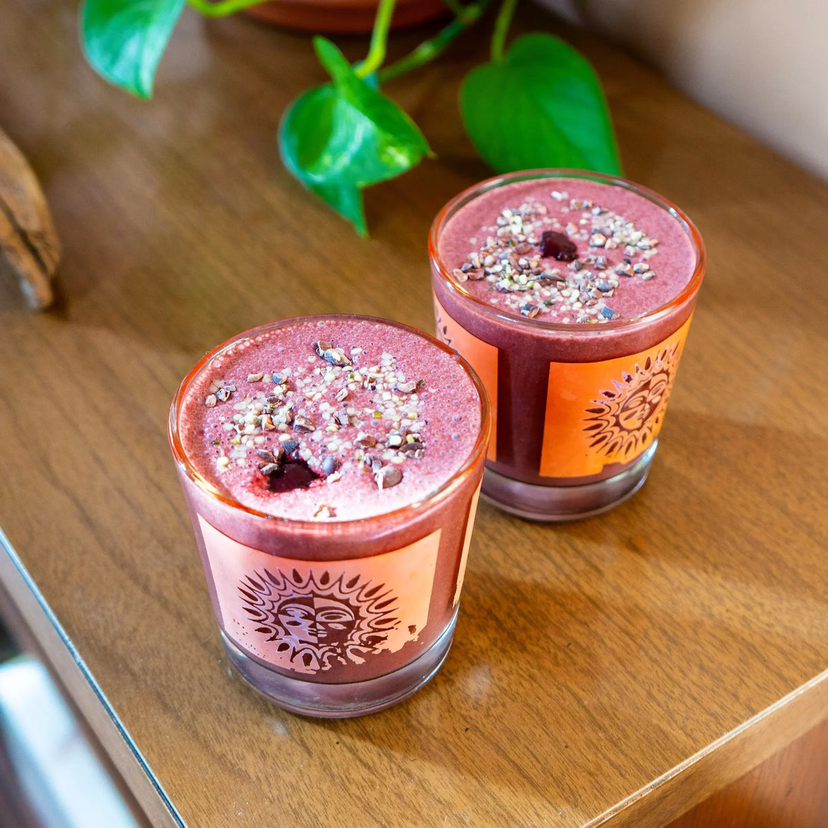 Two cherry chocolate cacao smoothies topped with cacao nibs