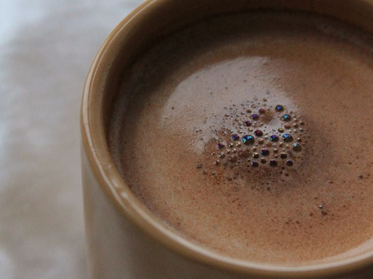 Close-up of a frothy cup of Ritual Cacao in a ceramic mug
