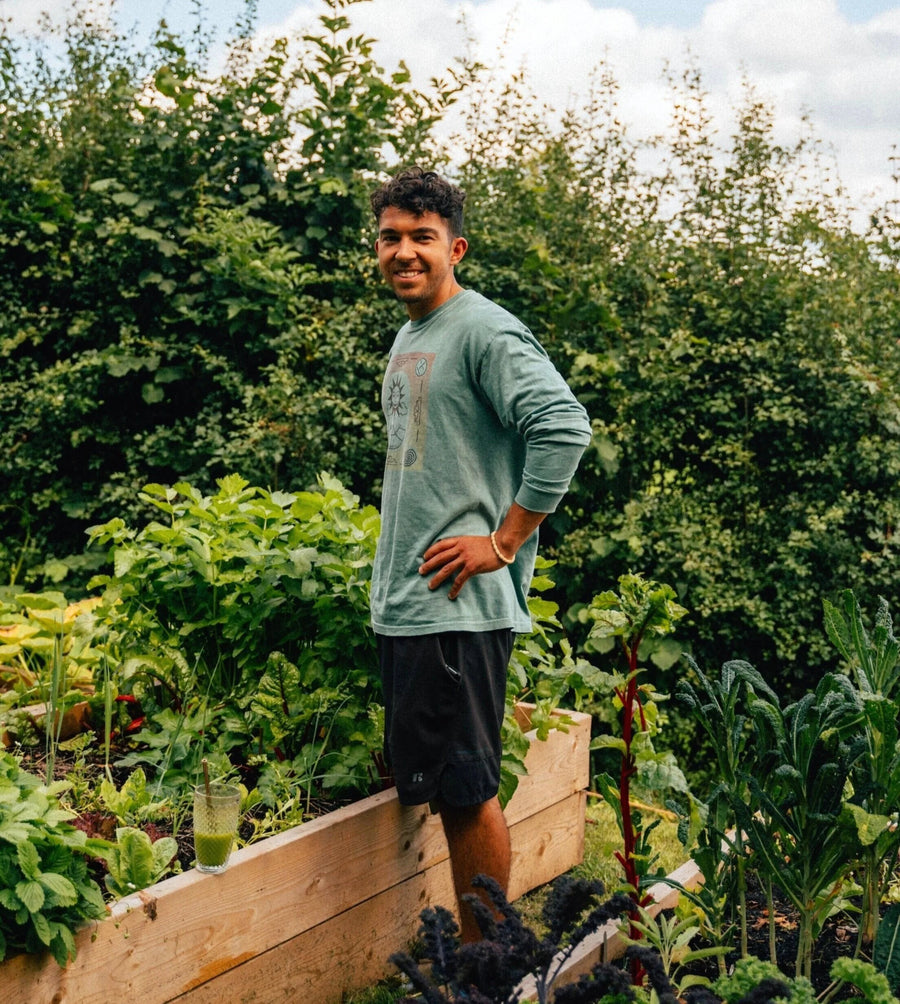Mavi Goods founder Jason Pabst standing in his vegetable garden