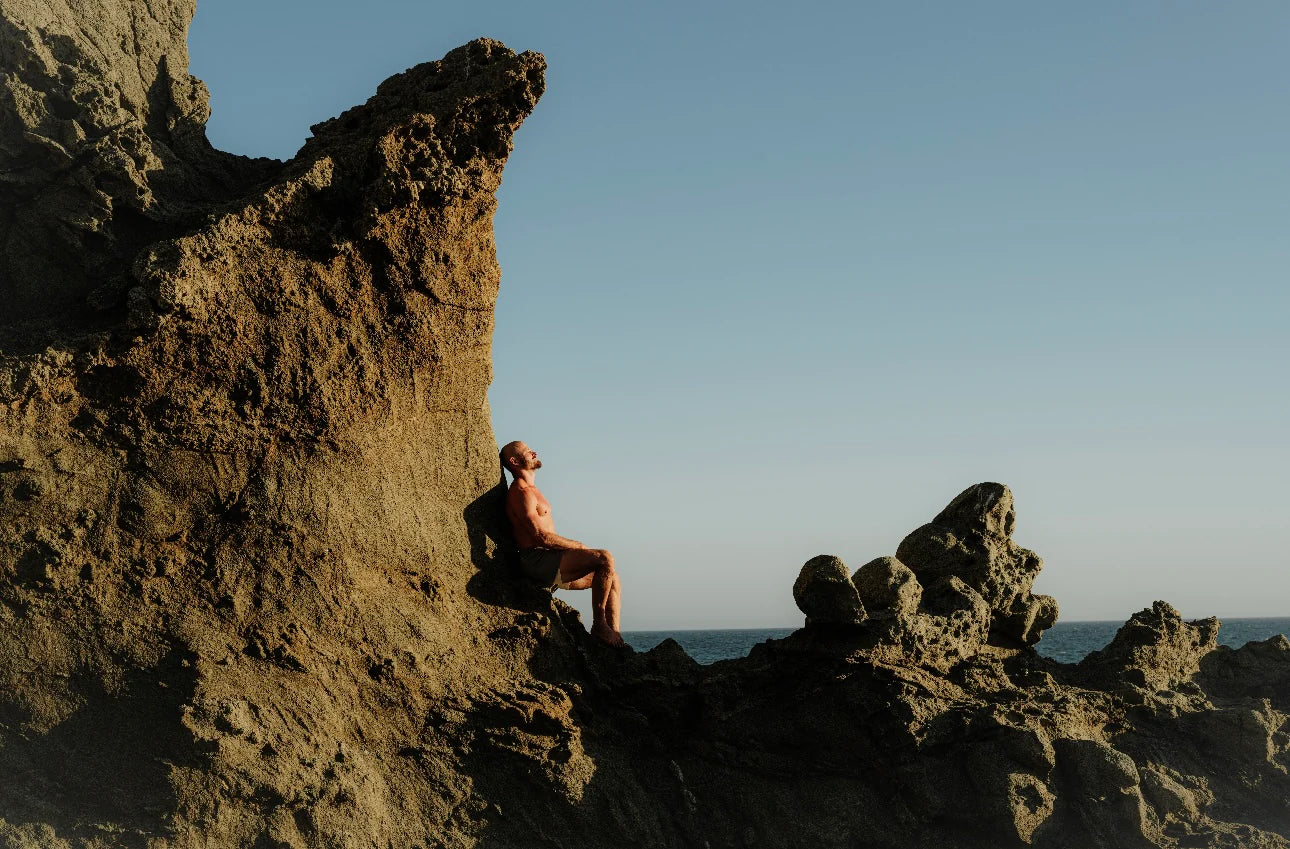 WHITE BALD MAN MEDITATING AT THE BEACH