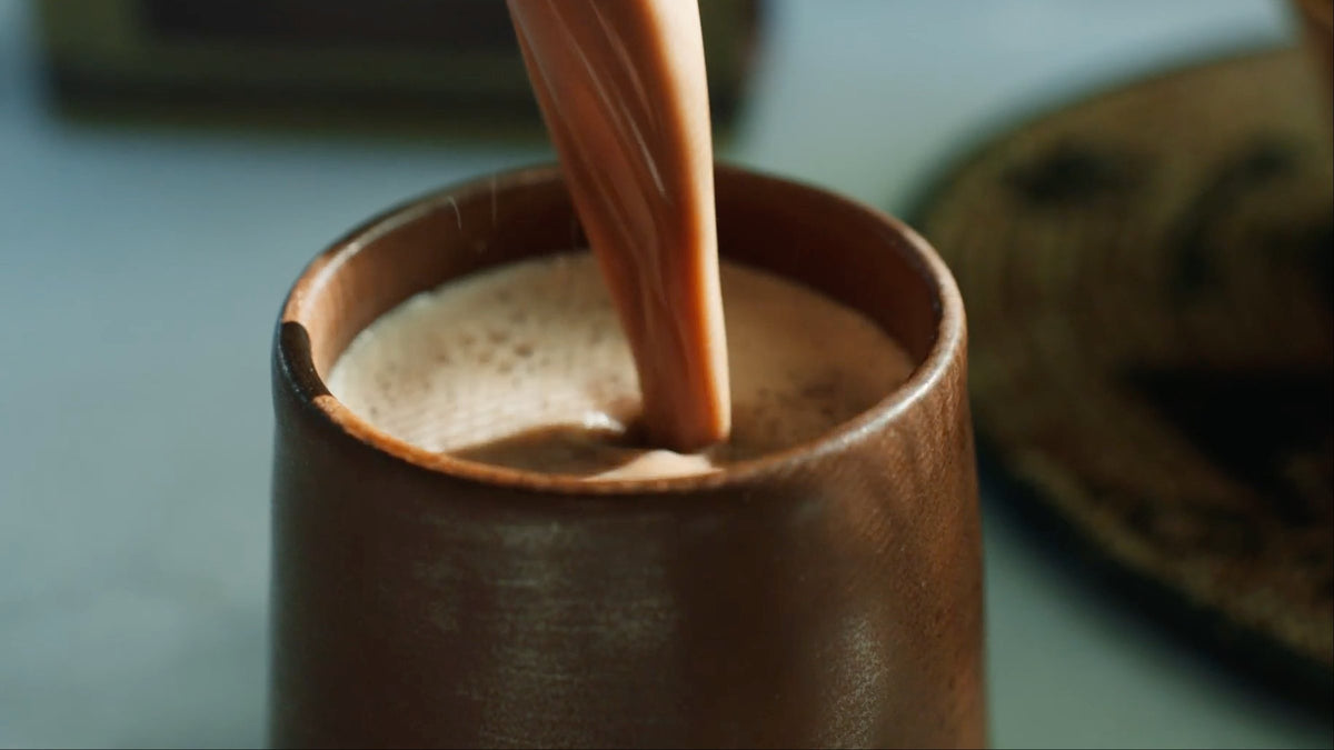 Cacao being poured into a handmade ceramic cup